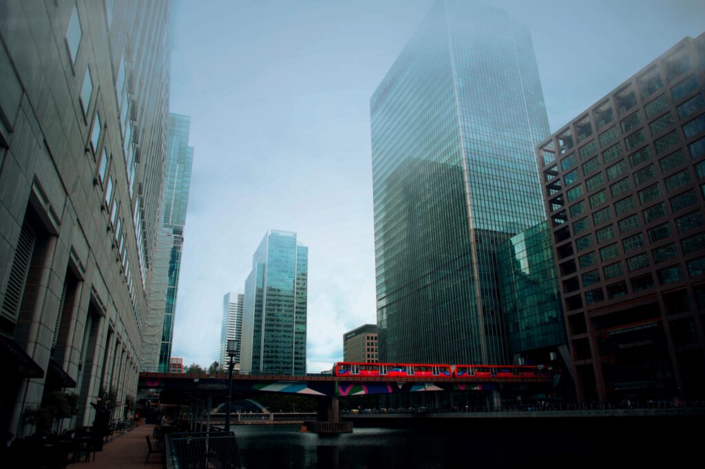 A train crossing a bridge between buildings over the River Thames